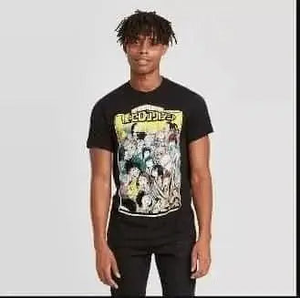A young man with short dreadlocks wears the SubscriptionApps Men's My Hero Academia Short Sleeve Graphic Crewneck T-Shirt, featuring colorful animated characters and RECOPIA text, standing against a plain light gray background.