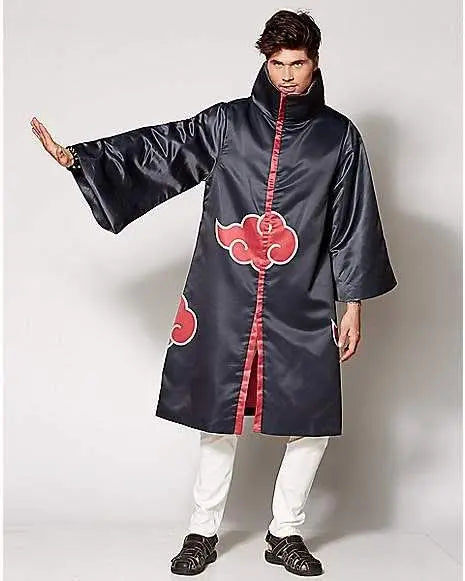 A person in a NorthAmericaTesting Akatsuki Robe inspired by Naruto cosplay—with dark blue fabric and red clouds—stands confidently, raising one arm; they wear white pants and black shoes.