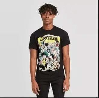A young person with short, curly hair faces the camera, wearing the US Audit Testing Men's My Hero Academia Short Sleeve Graphic Crewneck T-Shirt with colorful characters and "MY HERO ACADEMIA" in yellow on a black shirt. The background is plain white.