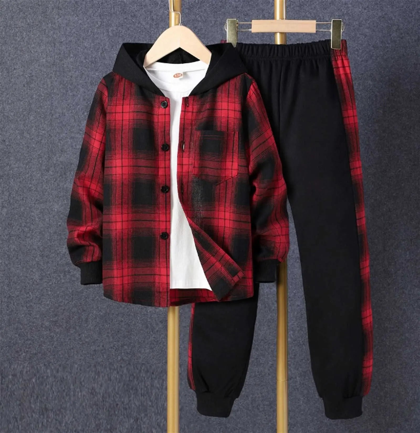 Reign + Sun toddler boy outfit: red and black plaid hooded shirt jacket, white tee, and black joggers with matching plaid stripes—perfect spring/autumn set for baby boys. Displayed on hangers against a gray background.
